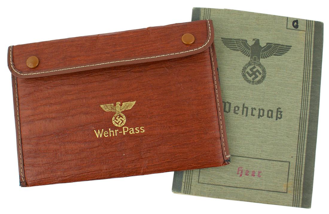 German WWII Army Wehrpass Czech: C-007 German WWII Army Wehrpass. Issued to a Czech/German in 1944. With a "Wehrpass - Notiz" and a written note stating prior service with a Czech Red Cross. With a snap - lid "ersatz" wallet (embosse