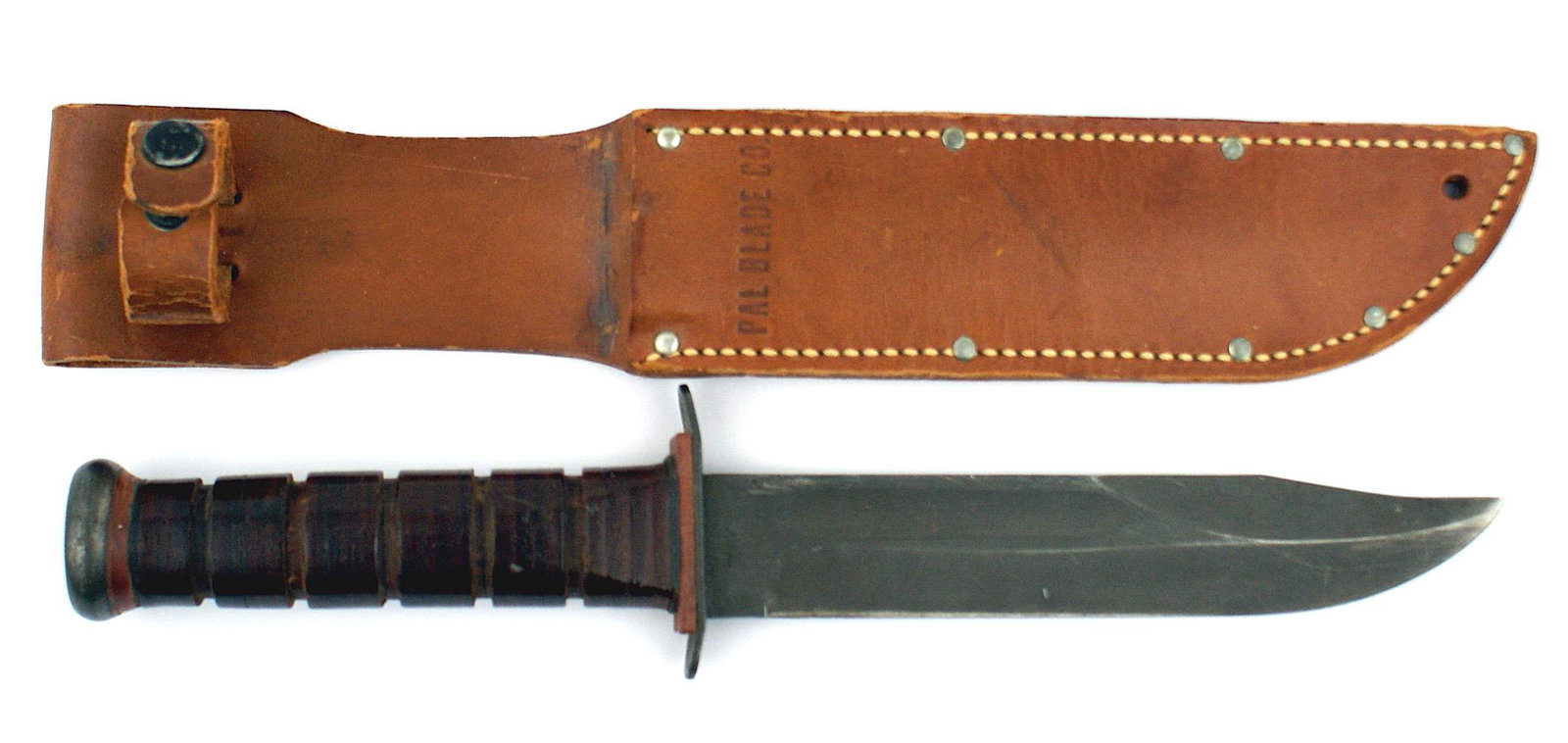 US WWII PAL Marine Corps utility knife: D-030 US WWII "PAL" Marine Corps utility knife. This is the same knife as the US Navy MK 2, with "PAL" and "USMC" on the parkerized 7" blade. Leather washers handle. Brown leather scabbard marked "PAU