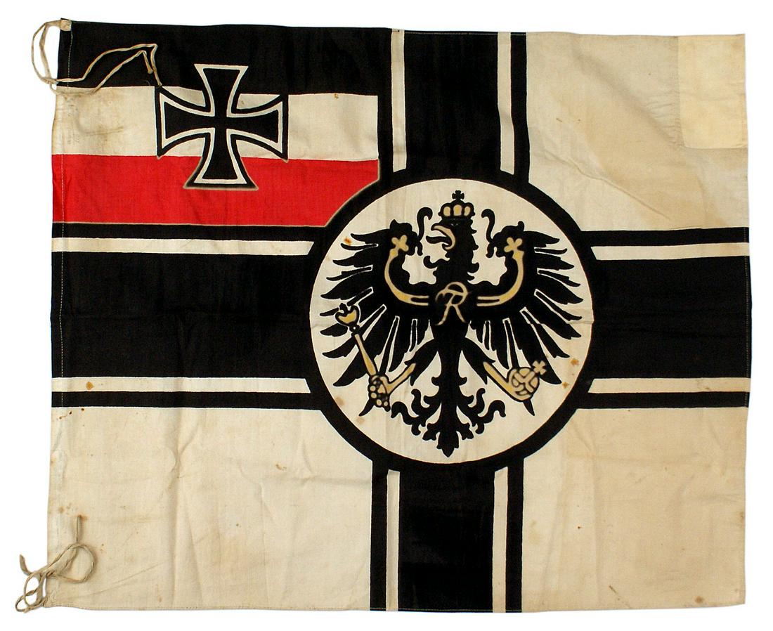 Imperial German WWI war flag: H-083 Imperial German WWI war flag. Iron Cross on the three National Colors/upper left panel. A Balkan Cross dissects the white background and has a 10 1/2" diameter round center bearing the crowned P
