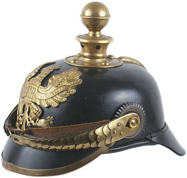 Prussian M1895 NCO Artillery helmet: E-15 Prussian M1895 NCO Artillery helmet. Solid black leather body. Brass eagle front plate, "hook-on" chinscales, visor trim, spine and base/ball top. Both National and Prussian, officer type, rosett