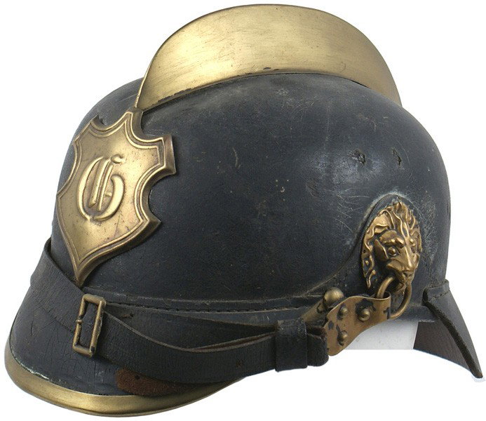 German black leather fire helmet: E-33 Black leather fire helmet. Solid body/visor with brass trim, "comb", side lion head bosses and a shield shaped plate with a cypher "G". Leather chinstrap and drawstring liner. Circa 1910-1930. II