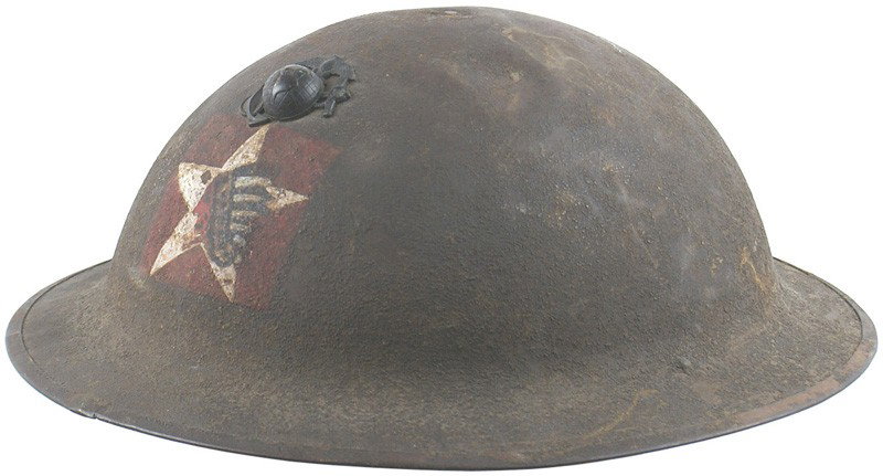 U.S. WWI 2nd USMC Division helmet: E-49 WWI 2nd USMC Division, 5th Regiment, 1st Battalion helmet. "Doughboy" type with a painted Indian head/star on a red square. Also an affixed darkened "EGA" insignia. 30% of the "sand" finish remai