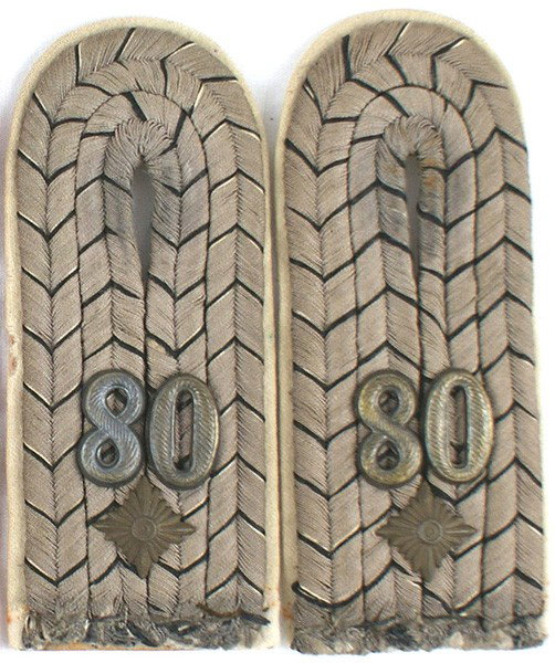 Prussian 80th Infantry 1st Lt. shoulder boards: H-53 Prussian 80th Infantry 1st Lt. Gray cord with black/white "V's", one "pip" and metal "80". White underlay (two small "nips"). S.I. Pair. II