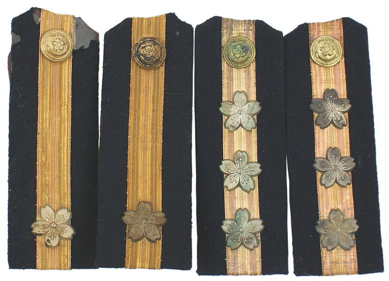 Lot of 2 Japanese WWII Navy shoulder boards: H-252 Lot of 2 pairs of Japanese WWII Navy shoulder boards: (1) Ensign. Dark blue with a gold "tape" stripe and a silvered cherry blossom. With gilt buttons. (2) Lieutenant - same as above, but with t