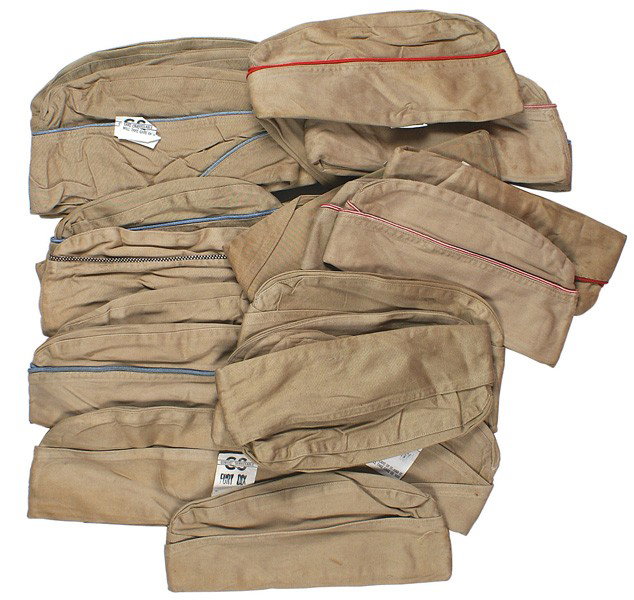Lot 28 U.S. WWII Army oseas summer caps: E-131 Lot of 28 U.S. WWII Army o'seas summer caps. Most have color piping (red, blue, white and maroon, orange and white, etc.). With tags "COMBAT SERVICEABLE", "FORT DIX" etc. Variables in bundles. A