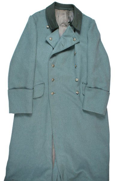 German WWII Army officer overcoat: F-48 Army officer's o'coat. Light O.D. "doeskin" with a dark green collar. No shoulder boards. Satin lining with a cloth strap/snap hook for a dagger. Two moth "nips" under hanger flap and moth tracki