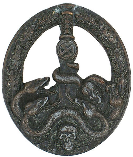 German WWII Anti-Partisan War Badge: B-148 Anti-Partisan War Badge - Bronze. Relief oak leaf decorated oval wreath, upper portion cut-out, "sun-wheel" swastika below hilt of broad sword - pointed downward between entangled serpents and a