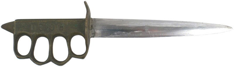 U.S. WWI trench knife: D-20 U.S. WWI trench knife. Cast brass handle with brass knuckles and a round guard. Grip is marked "U.S. 1918", reverse has scratched in "PA 1940". A French made piece which was re-issued at the star