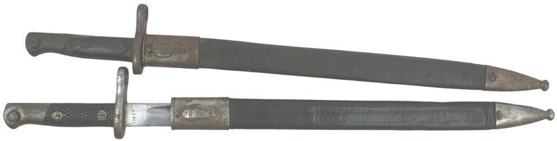 Lot 2 Spanish Mauser M1893 bayonets: D-105 Lot of 2 Spanish Mauser M1893 bayonets. One with flat wood grips, the other with checkered grips. Both with 15 ½" blade (gray) and a steel throat and tip on a leather scabbard. II-