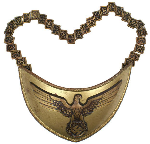 German WWII NSDAP standard bearer gorget: H-214 NSDAP standard bearer's gorget. Bronzed crescent shape bearing a 3 ½" x 7" applied political eagle/swastika. Oak leaf border. Reverse lined in green felt. With original chain consisting of alte