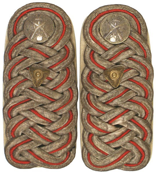 Danish Lt. Colonel Pioneer shoulder boards: H-296 Danish Lt. Colonel Pioneer dress shoulder boards. Intertwined silver bullion and red cord with a triangular "pip" and a silver button (relief crossed rifles/spade) on white underlay. Circa 1900.