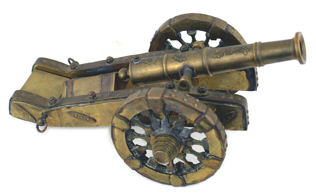 Model of 17th century European field cannon: R-002 All brass model of a 17th century European field cannon. 6" movable barrel with a flared muzzle. Carriage and wheels have simulated metal linings and reinforcements. Chest mounted on back of car