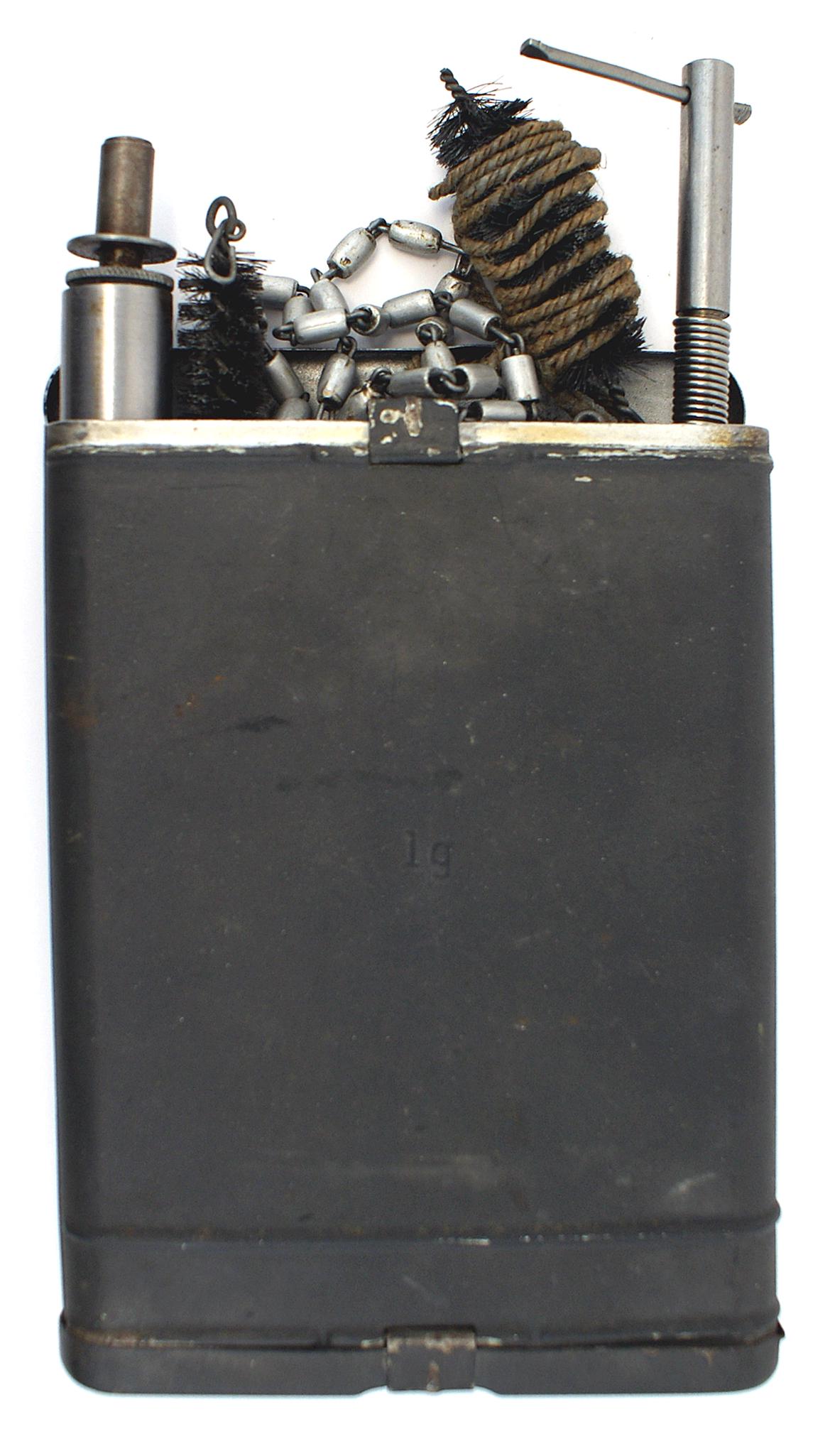 German WWII cleaning kit Anti-tank Rifle Pz. B 39: M-055 German WWII cleaning kit for the Anti-tank Rifle Pz. B 39. Same configuration as the tobacco-can" for the K98 Mauser Rifle, but larger. 7" x 5" with cords, chain, an oiler, several brushes and a