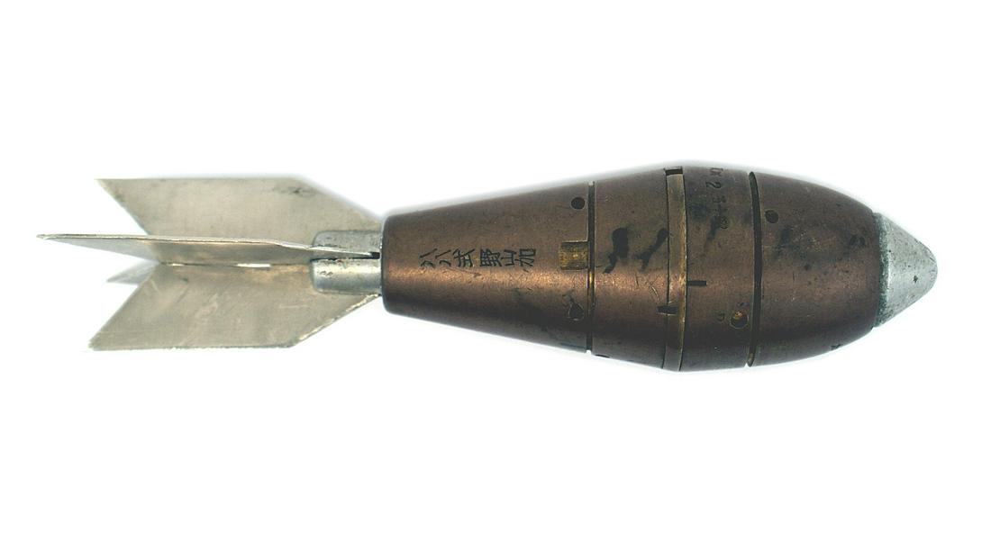 Japanese 1933 Type 88 grenade: M-065 Japanese 1933 Type 88 grenade, Well marked cylindrical body with a pressure sensitive nose and four metal tail fins. Overall length 5 1/2". Rare. II