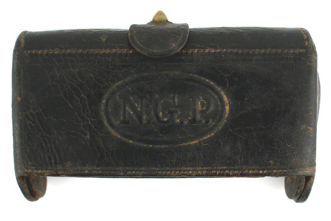 US M1876 McKeever cartridge box: K-134 US M1876 McKeever black leather cartridge box. 3 1/2" x 6 1/2" with a top brass finial/locking strap. Embossed oval holding "N.G.P" on front. Two rows of 10 web cartridge holder loops for rifle 