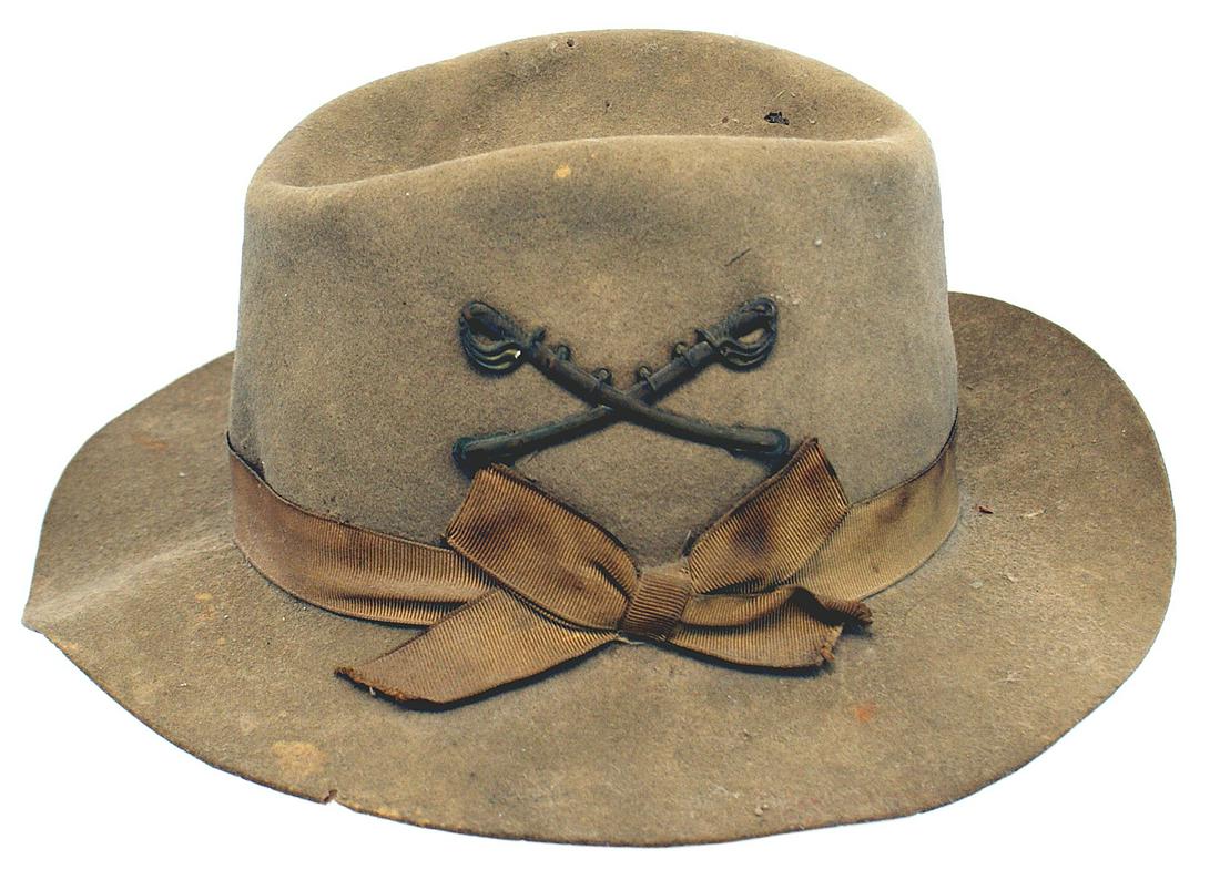 US Spanish American War Cavalry hat: K-180 US Spanish-American War private purchase, civilian version of the Cavalry Campaign hat. Drab felt but with a shorter brim and ribbed silk ribbon/bow. Aged patina on the affixed crossed swords in