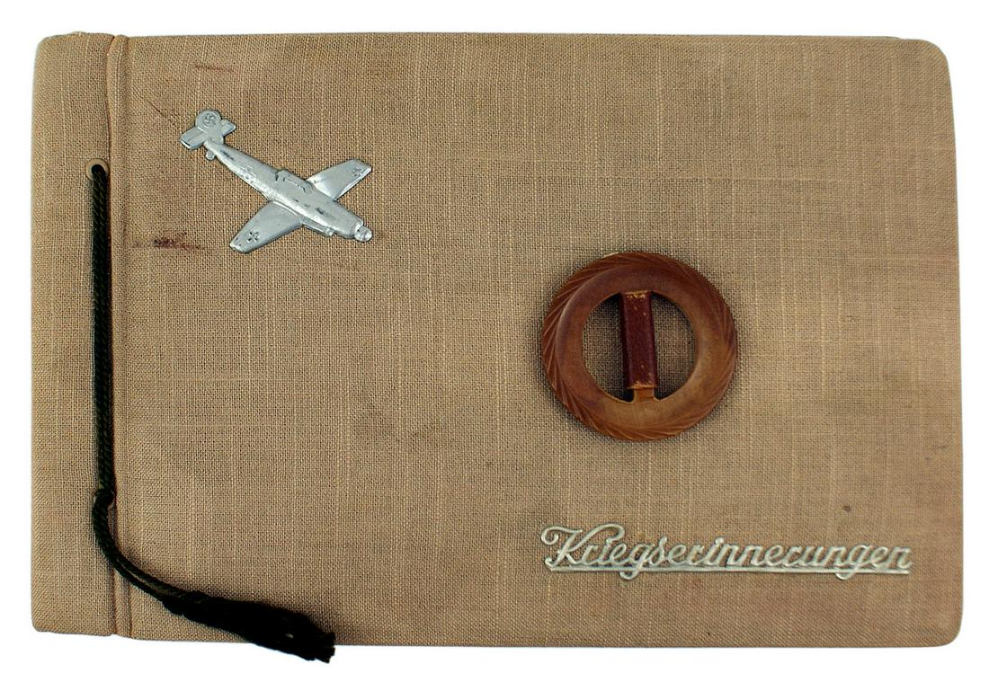 German WWII album depicting service in the RAD: L-019 Third-Reich album depicting service in the RAD (National Labor Service) and the Luftwaffe. Metal profile of an ME-109, a large wooden bakelite "O" and "War memories" on the linen cover. Time in