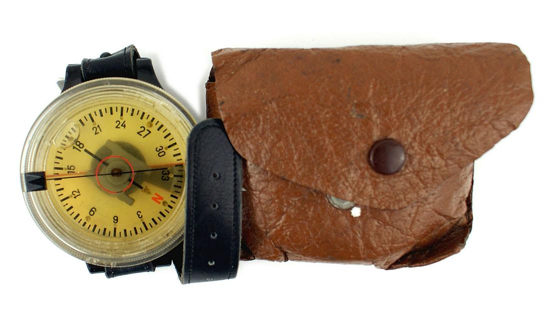 German WWII Luftwaffe pilot wrist compass: N-027 Luftwaffe pilot's wrist compass. Round 2 1/4" diameter clear plastic encased floating magnetic needle. Reverse marked "AK 39 - F123235 - 1". Leather wrist watch strap. With a synthetic leather c