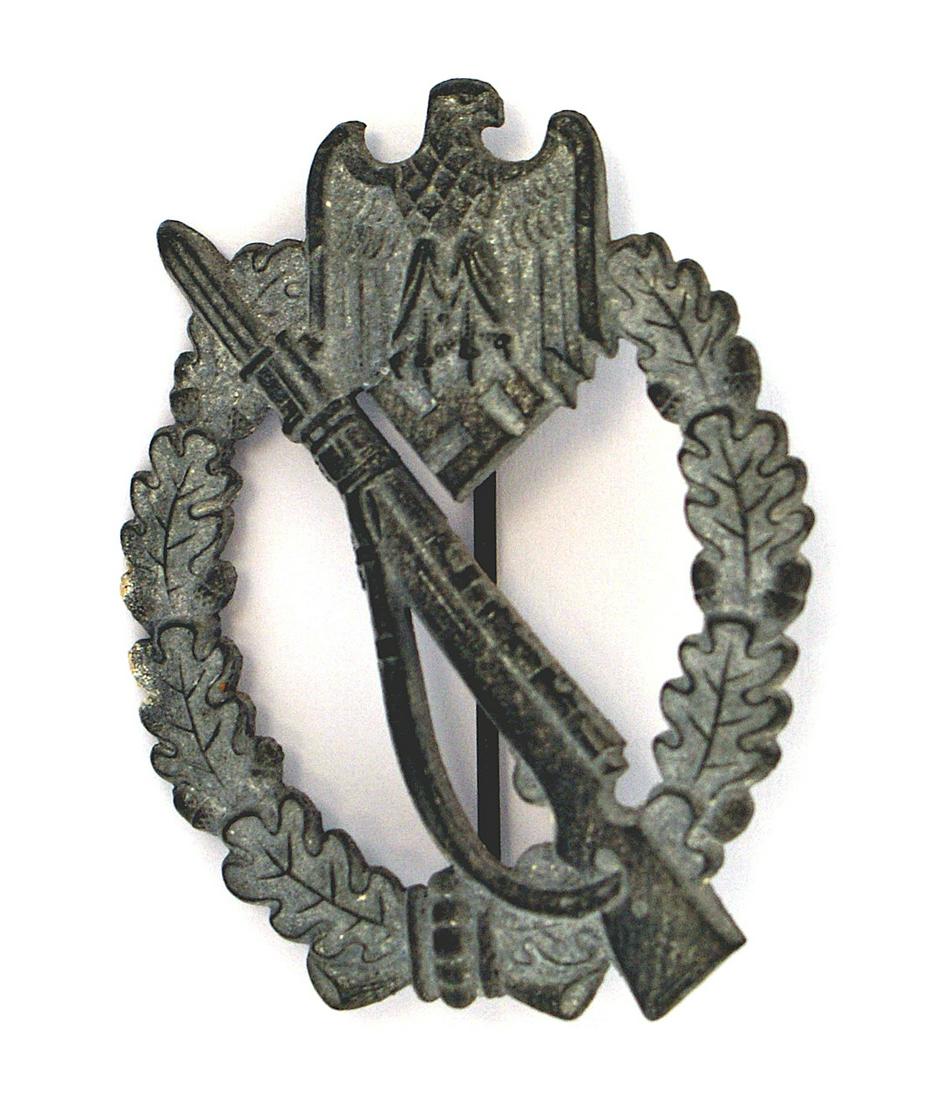 German WWII Army Waffen SS Infantry Assault Badge: B-048 German WWII Army/Waffen-SS Infantry Assault Badge. Convex shape. Rifle with fixed bayonet on an open wreath with an eagle/swastika at the top. Wartime metal - shows minute traces of the silver f
