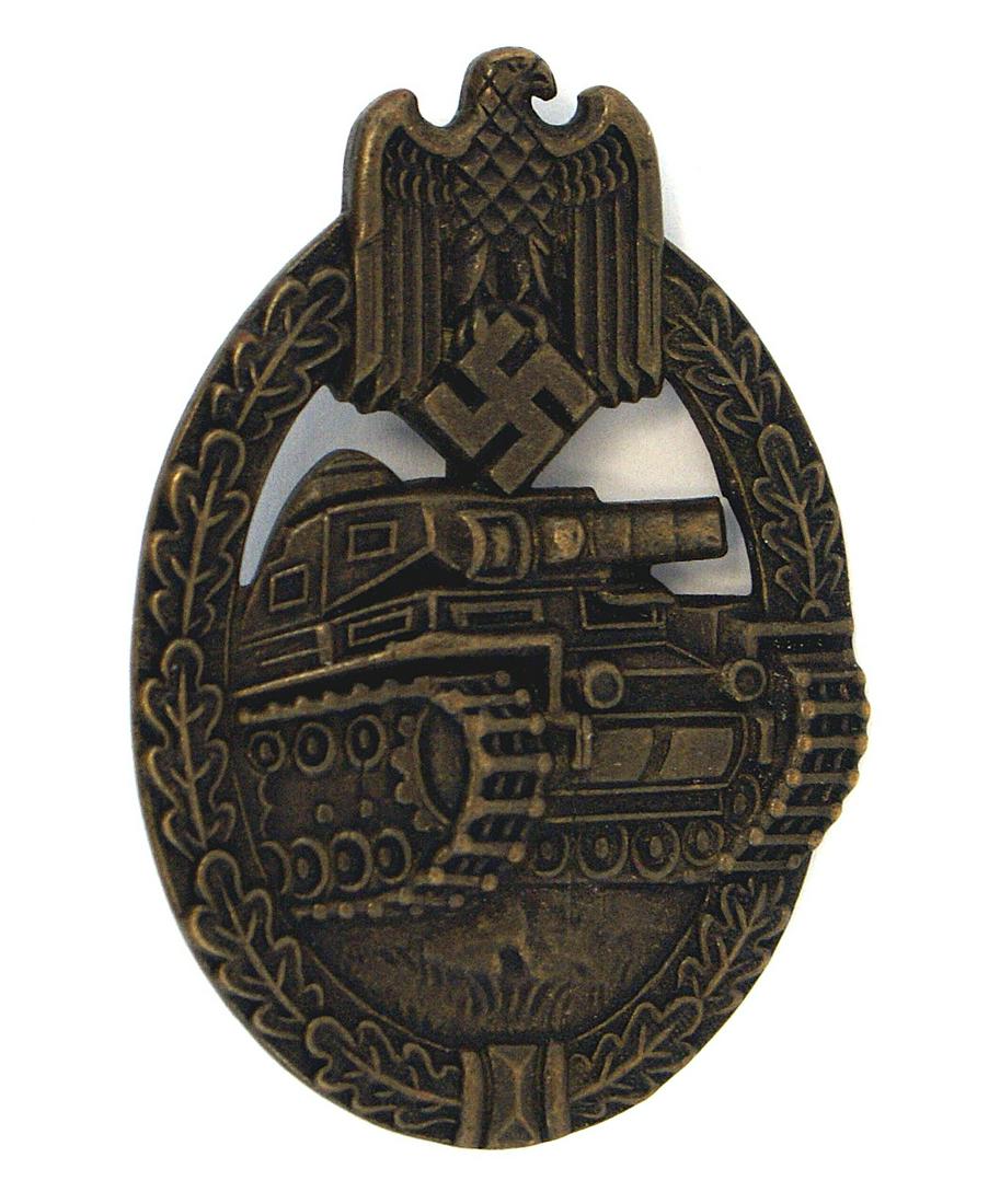 German WWII Army Waffen SS Panzer Badge: B-052 German WWII Army/Waffen-SS Panzer Badge. Bronze - solid type. Relief tank within an oak leaf wreath - eagle/swastika at top. Reverse marked with maker's "JFS" logo. II