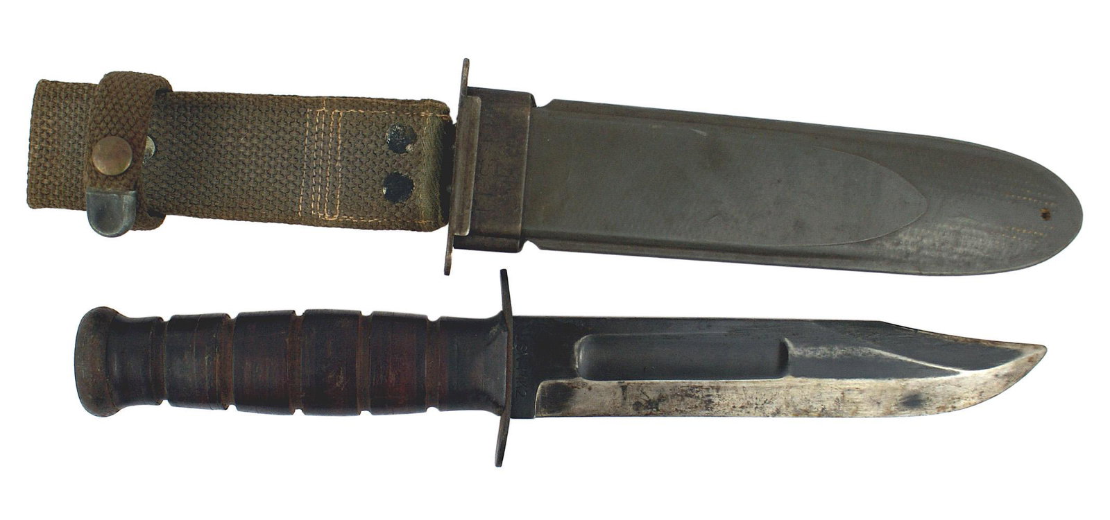 USN Mark 2 WWII combat knife: D-017 USN. Mark 2, WWII combat knife. Darkened flat pommel and crossguard. Leather washer handle. 6 7/8" blade with a 2 1/2" fuller and "clipped" point. Dark bluing is still intact on the entire lengt