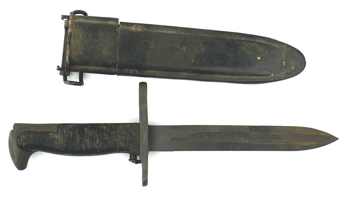 Variation US M1942 knife bayonet: D-058 Variation US M1942 knife-bayonet. Parkerized eagle head pommel and unmarked crossguard. Lined black plastic grips. Parkerized 7/8" wide, 6 1/2" blade. Blackened M-7 type metal throat and scabbar