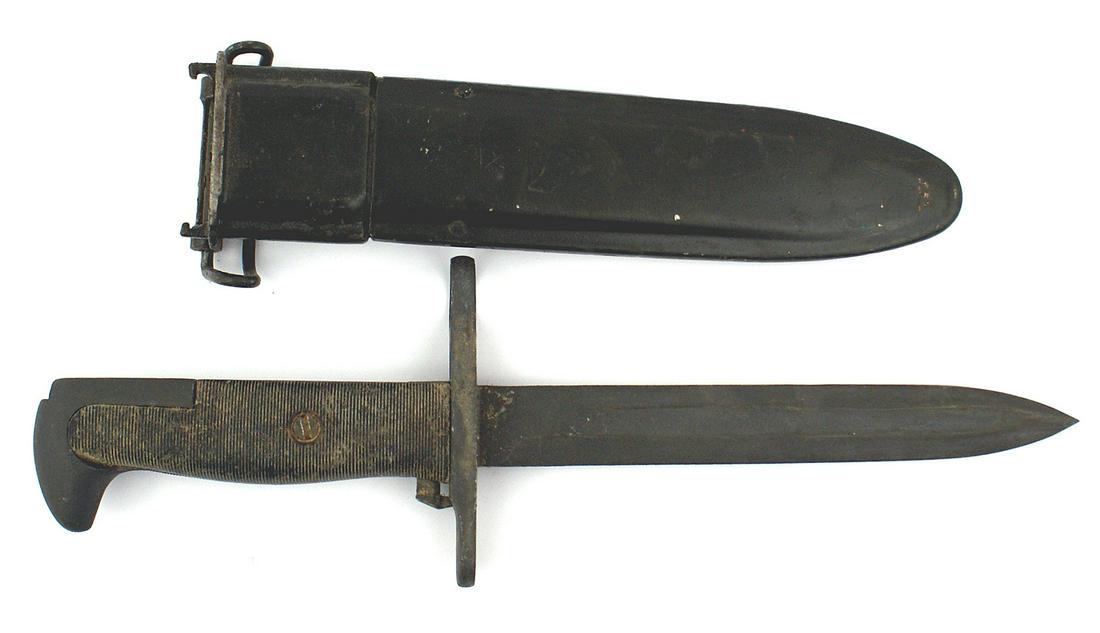 Variation US M1942 knife bayonet: D-060 Variation US M1942 knife-bayonet. Parkerized eagle head pommel and unmarked crossguard. Lined black plastic grips. Parkerized 7/8" wide, 6 1/2" blade. Blackened M-7 type metal throat and scabbar