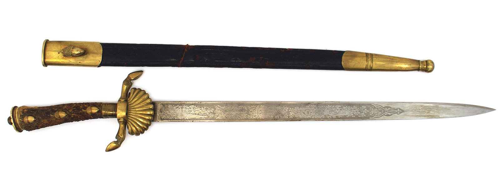 Imperial German hirschfanger hunting dagger: D-073 Imperial German hirschfanger. Stag grip with three brass acorns and lined flat pommel crossguard with deer hoof finials and clam shell guard. Blade etched with flags and floral work on both side