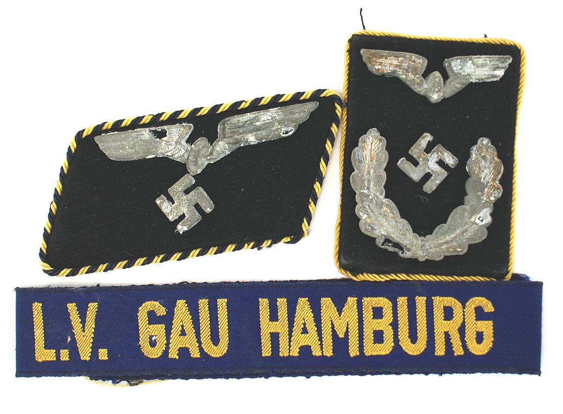 German WWII cloth insignia lot Railways ccufftitle: H-018 German Third-Reich cloth insignia: (1) Two different single National Railways collar tabs. Both with metal winged wheel/swastika and one has additional oak leaves. Metal shows age. (2) "L.V. Gau