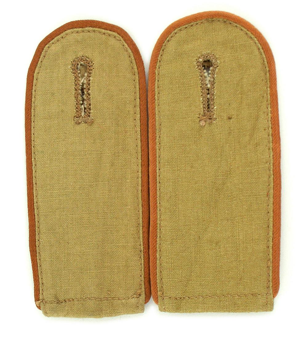 German WWII AK Panzer shoulder boards: H-021 German WWII Afrika Korps Panzer, enlisted man's slip-on shoulder boards. Tan with subdued pink piping. Appears unissued. Pair. II+