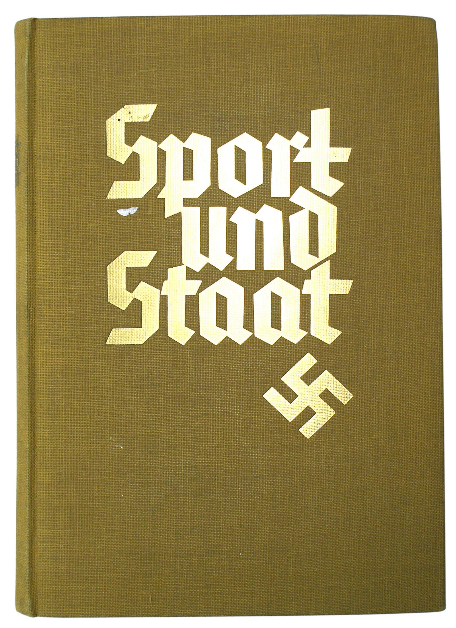German WWII book Sport und Staat: I-023 "Sport und Staat". 1934 hard cover cigarette card reference. 265 photo cards showing the history of sports as well as developments of various sports in Third Reich Germany. Fold-out of a major s