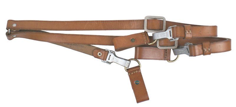 German WWII NSDAP Y straps: N-5 Pair of NSDAP brown leather "Y" straps. Pebbled buckles and snap hooks are marked "RZM-AU" and "DRGM M5/289". With three matching leather belt loops with gilt "D" rings. Back of strap is stamped "