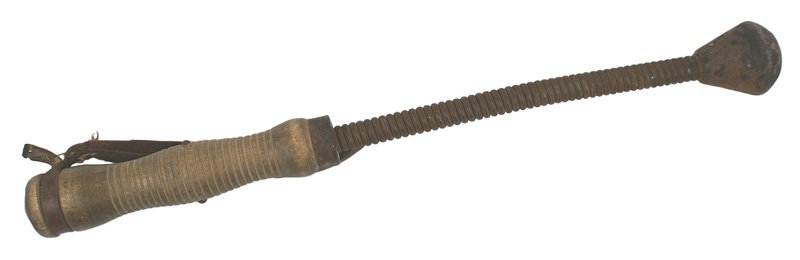 Austrian WWI trench club: N-34 Austrian WWI trench club. 10" long stiff coiled spring with a pear-shaped cast iron head. 6 3/4" shaped, ribbed wood. With the original leather hand loop. Shows some wear. Overall length 16 1/2".