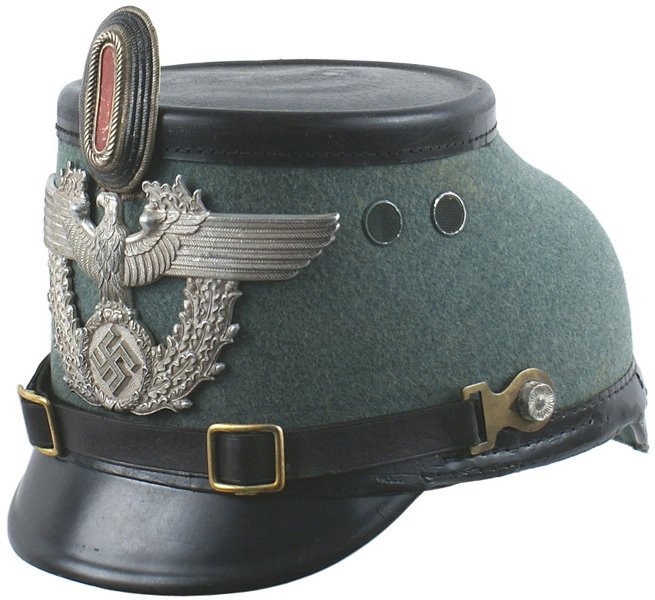 German WWII Municipal Police shako: E-50 Municipal Police other ranks shako. Green felt covered body with a black patent leather top, front and back visor and chinstrap (with brass buckles and boss attachments). Large 3 1/4" x 6 1/4" ea