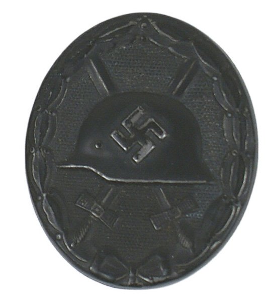 German WWII Wound Badge Black: B-104 Wound Badge - Black. Relief helmet/swastika/crossed swords - on a pebbled background. Oak leaves border. II