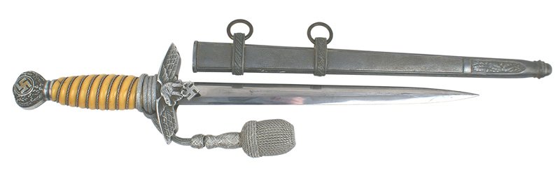 German Luftwaffe 2nd Model dagger: D-12 Luftwaffe officer 2nd Model dagger. Silver wire wrapped deep yellow grip (hairline at top). Some gilt remains on the relief swastika on the oak leaf decorated pommel. Flying eagle/swastika crossg