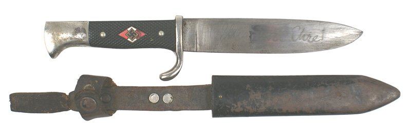 German WWII HJ Hitler Youth dagger: D-17 HJ (Hitler Youth) dagger. Enameled red/white diamond with a swastika - set into a checkered black plastic grip. 50% of back grip is missing. Nickeled "bird head" pommel (worn spot) and crossguard