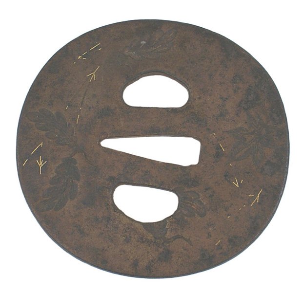 Japanese tsuba Samurai sword 19th Century: D-119 Japanese tsuba. Oval iron 3 1/8" x 3", with two types of engraved leaves and small gold inlayed linear designs. Circa 19th century. II