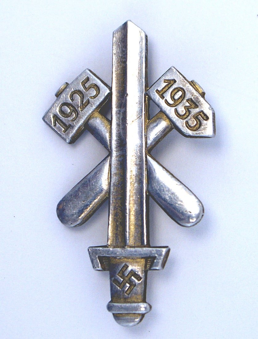 German WWII Gau Essen Badge commemorative: B-015 German Third-Reich commemorative Gau Essen Badge. Broadsword with crossed hammers - dated "1925" and "1935". Reverse is maker marked "HOFFSTATTER - BONN". Pin-back. II