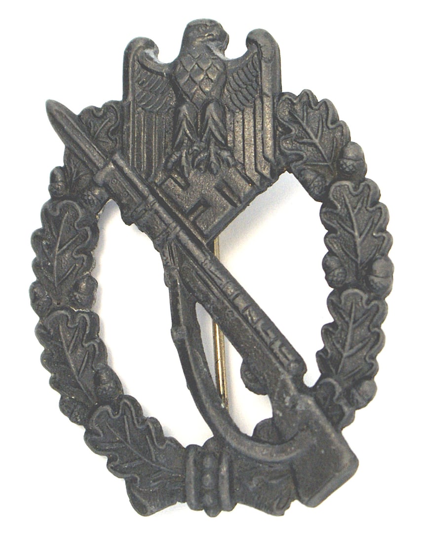 German WWII Infantry Assault Badge Silver: B-056 German WWII Infantry Assault Badge - Silver. Eagle/swastika at top of an open oak leaf wreath - holding a rifle with a fixed bayonet. Darkened wartime solid construction with only minute traces 