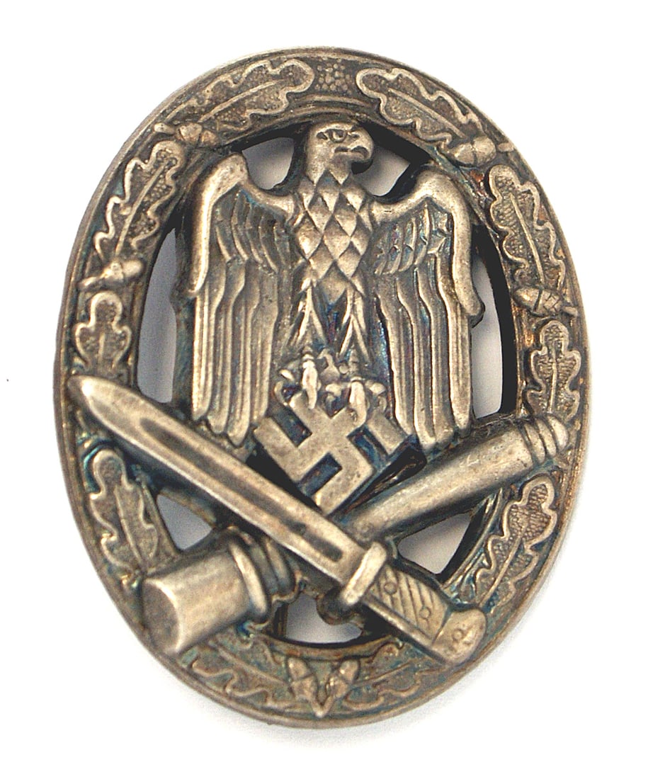 German WWII General Assault Badge Silver: B-061 Army/W-SS General Assault Badge - Silver. Eagle/swastika and crossed bayonet/stick grenade - on an open oak leaf wreath. Stamped variety. II