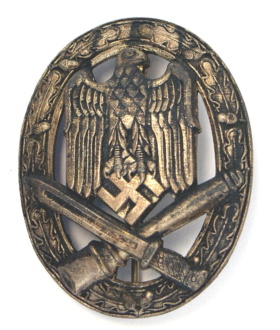 German WWII General Assault Badge Silver: B-063 Army/Waffen-SS General Assault Badge - Silver. Heavy type. Relief eagle/swastika and crossed bayonet/stick grenade - on an open oak leaf wreath. II