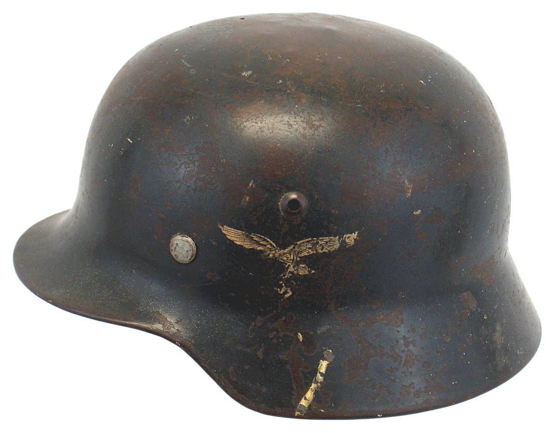 German WWII Luftwaffe M1935 helmet: E-075 German WWII Luftwaffe M1935 double decal "Stahlhelm". Blue-gray finish shows wear. Several small dents on top. Eagle/swastika shows wear, would rate 60%. National colors shield shows scratches a