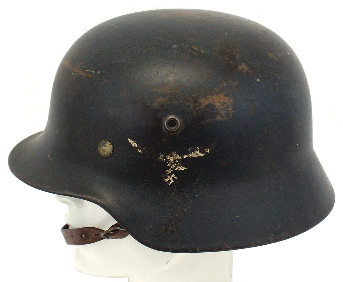 German WWII Luftwaffe M1940 helmet: E-078 German WWII Luftwaffe M1940 single decal "Stahlhelm". Blue-gray finish shows field wear. Eagle/swastika shows wear and would rate 50%. Brown leather drawstring liner is in good condition. Origin
