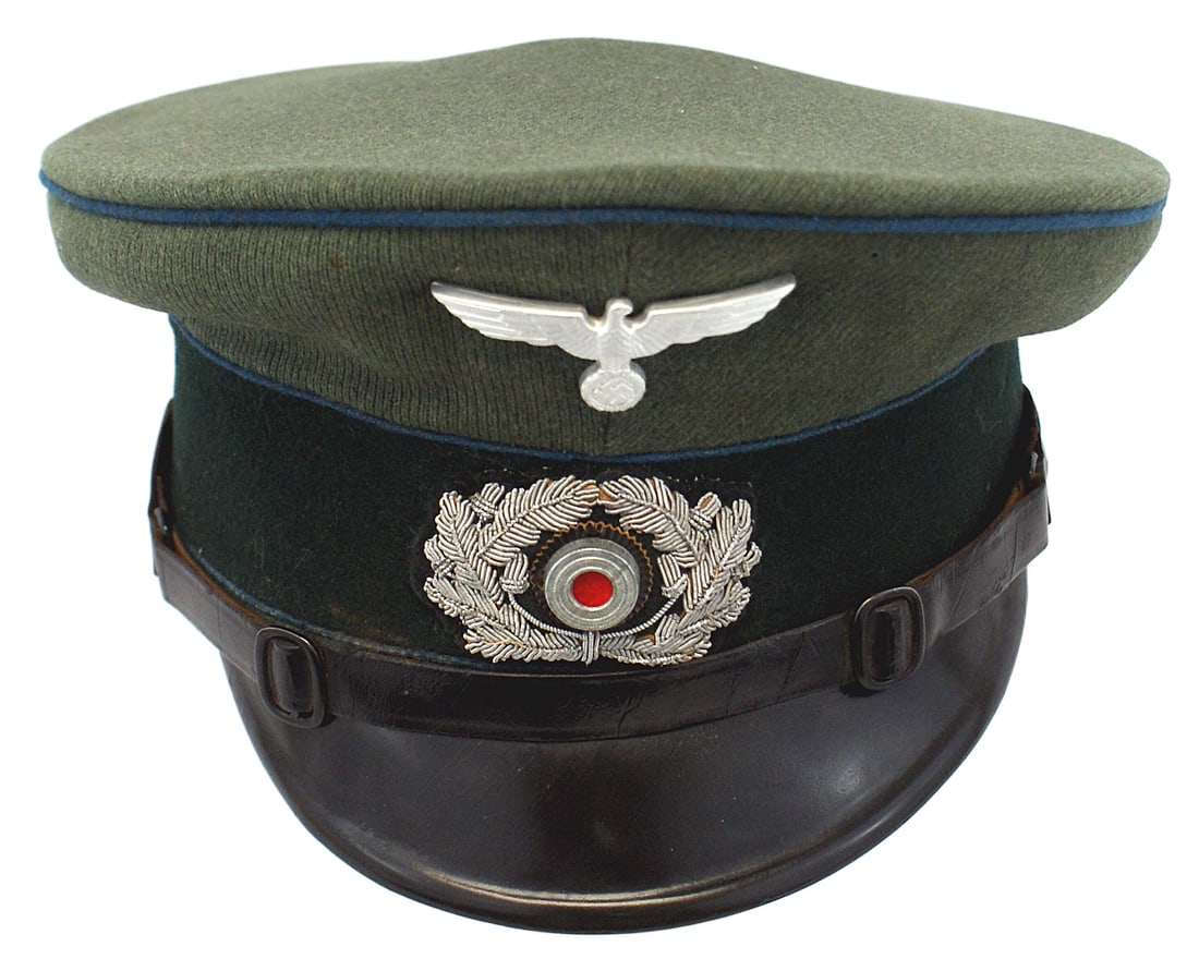 German WWII Army Transport peaked cap: E-112 German WWII Army Transport EM/NCO peaked cap. Ribbed wool doeskin with a dark green band and blue piping. Silver metal eagle/swastika and an embroidered wreath/rosette (probably a case of expedi