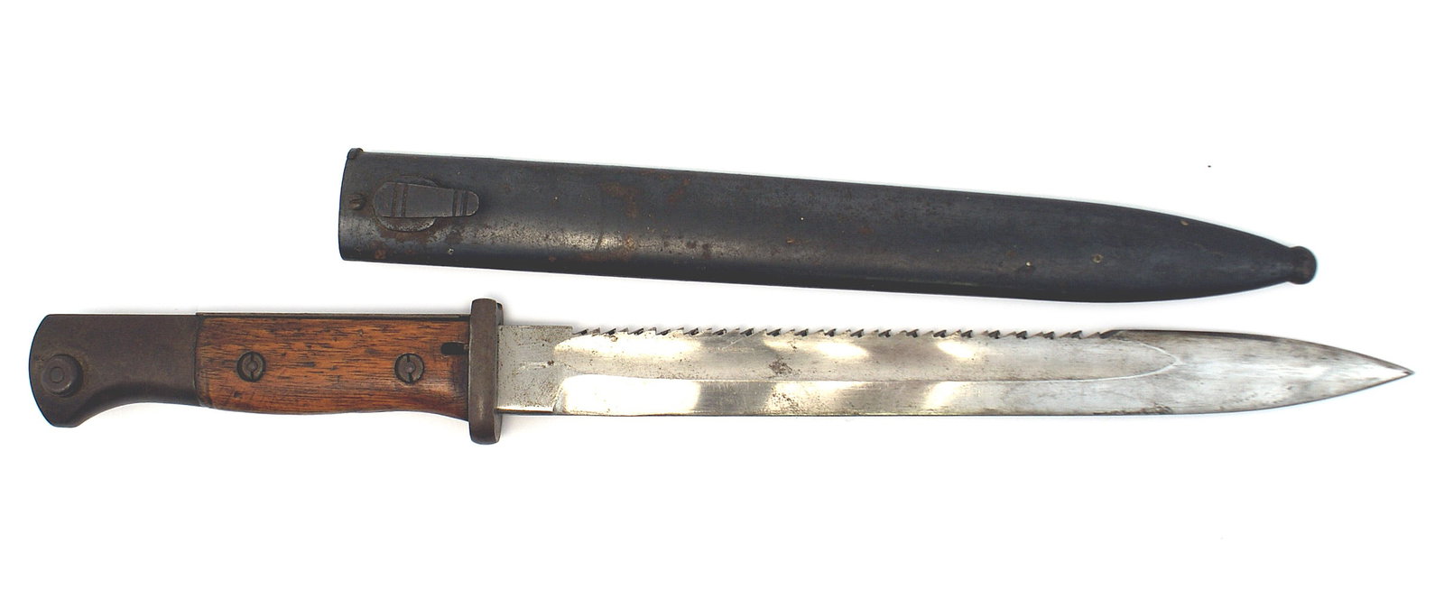German S84/98 saw-back bayonet: D-125 German S84/98 saw-back bayonet. Darkened finish on the bird-head pommel, flash guard and short open muzzle ring crossguard. Wood grips. 10" fairly clean unmarked blade, with three "fingerprints"