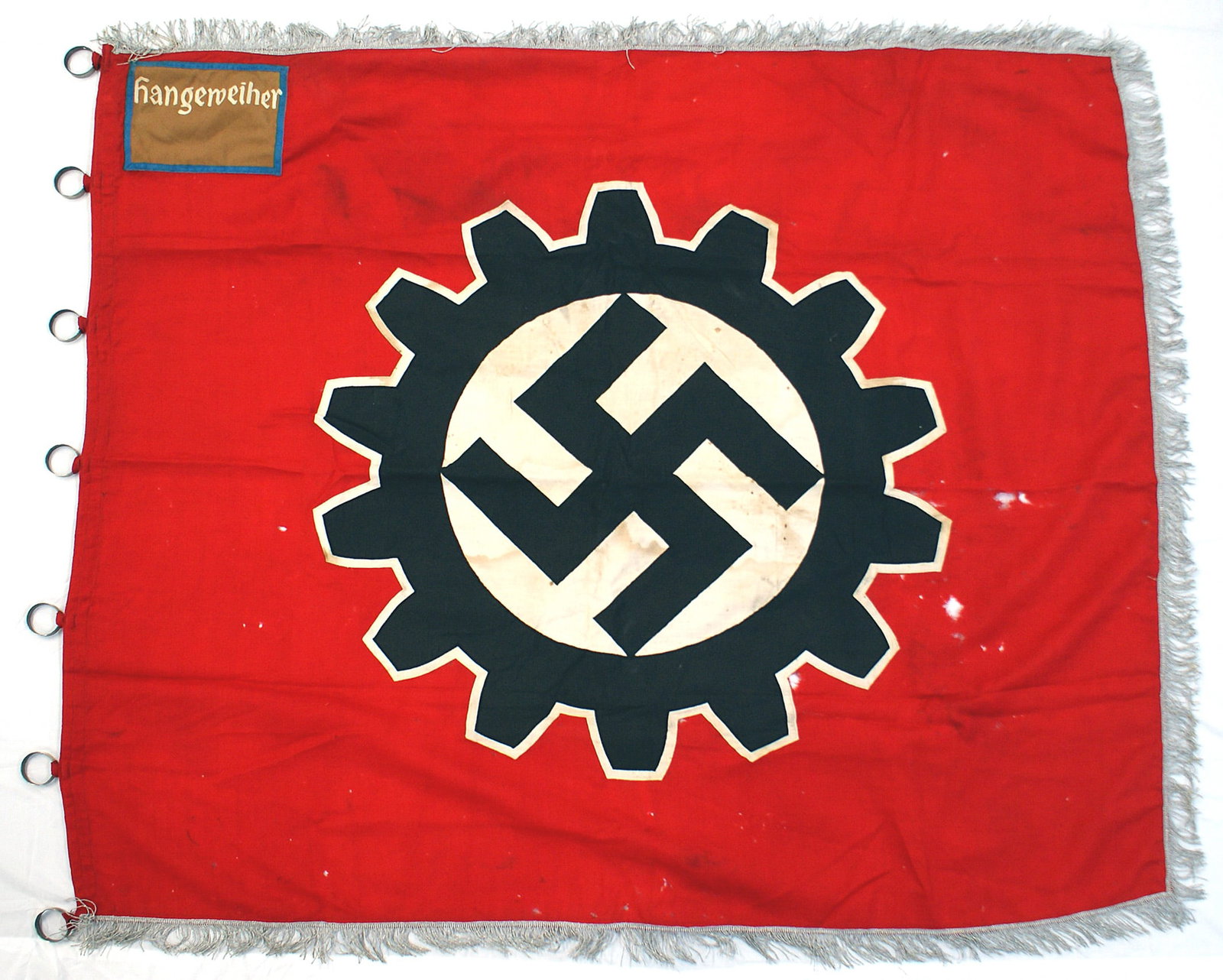 German WWII NSDAP type District standard flag: H-093 N.S.D.A.P. type German Labor Front District Standard. Large 30" black swastika and cogwheel on a white outline sewn to a red field. Upper left corner holds a blue outline 6" x 8" brown "patch" -