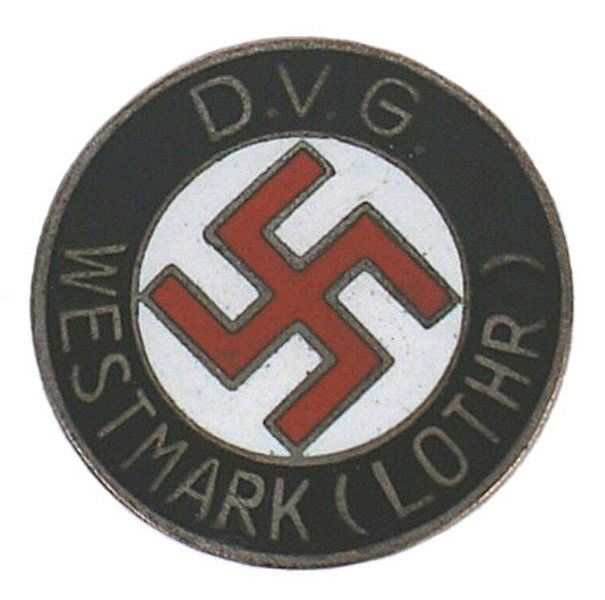 German WWII NSDAP regional badge: B-30 German WWII NSDAP regional member's enameled badge. Red swastika on a white field with gilt lettering "D.V.G. WESTMARK (LOTHR)". Reverse marked "W. REDO- SAARLAUTERN". II