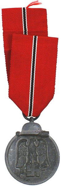 German WWII Eastern Front Medal: B-145 German WWII Eastern Front Medal. Darkened finish on a silvered perimeter with a helmet/stick grenade. Obverse bears a relief black-gray eagle/swastika. Ring marked "55" (J.E. Hammer + Sohne in G