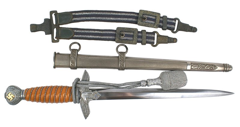 German WWII Luftwaffe 2nd Model dagger: D-15 German WWII Luftwaffe 2nd Model officer's dagger. Gilt relief swastika on oak leaf decorated round pommel. Flying eagle/swastika crossguard. Silver wire wrapped orange grip. 10" clean blade marke